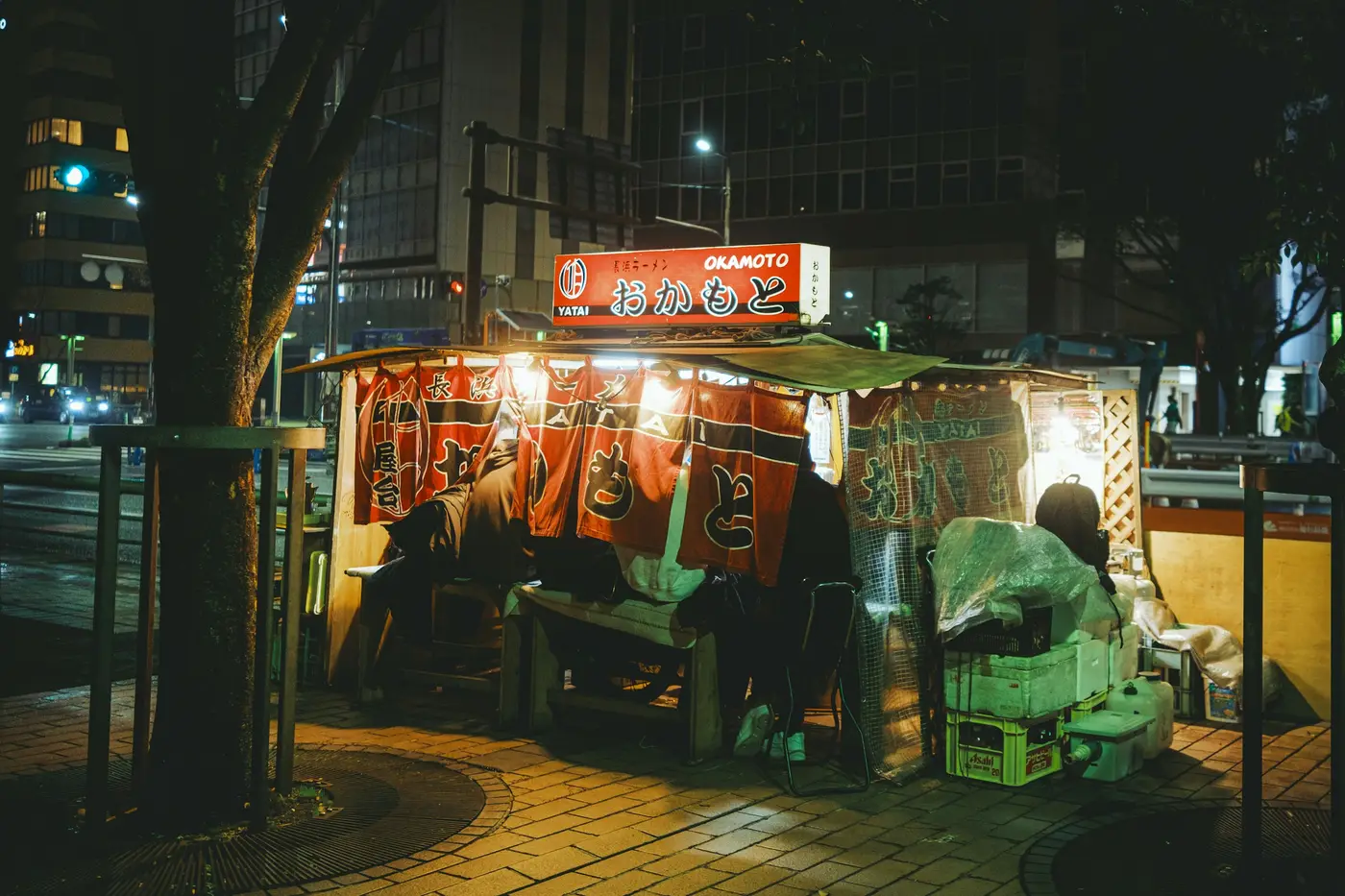 A single yatai food stall glowing on a Fukuoka street at night